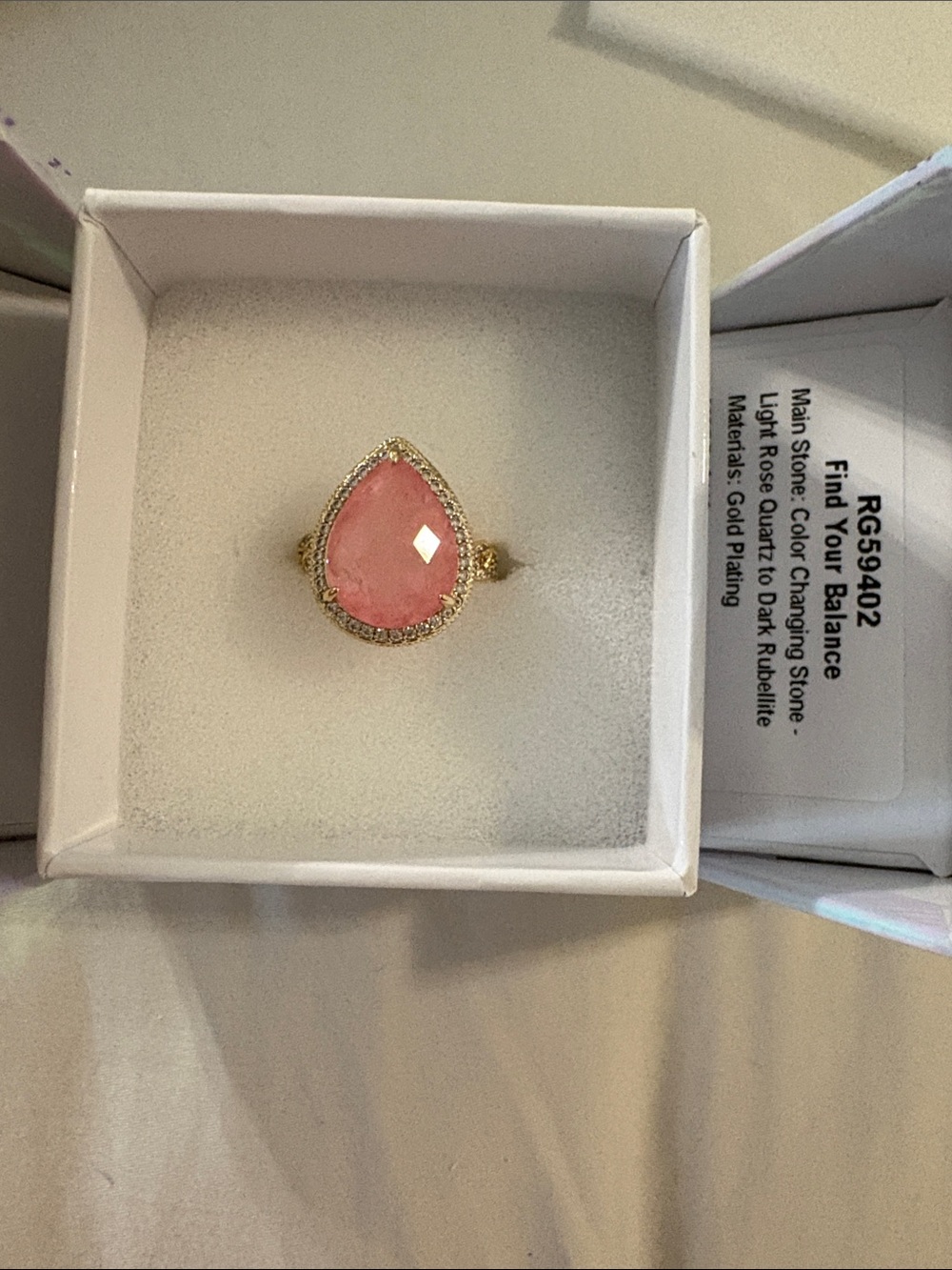 Gold-Plated Ring with Pink Teardrop Stone and Halo